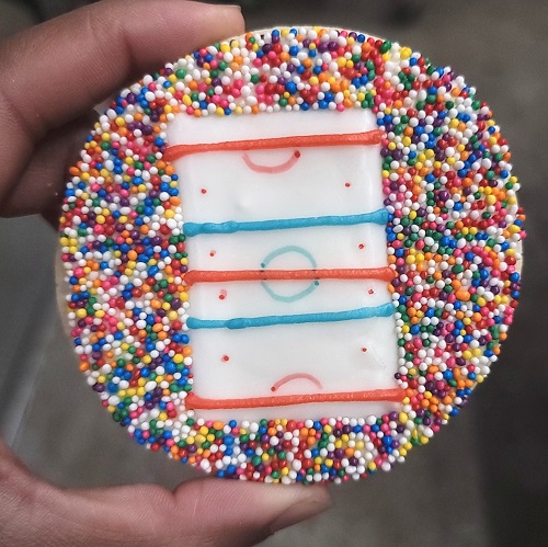 Custom round hockey rink cookie with sprinkles for a Guelph Gryphons hockey team in Guelph Ontario