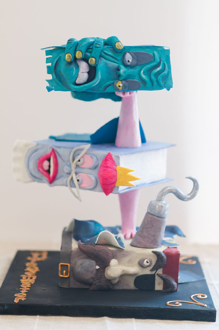 Custom stacked book cake with a monster book, a queen book and a pirate book in Kitchener Ontario
